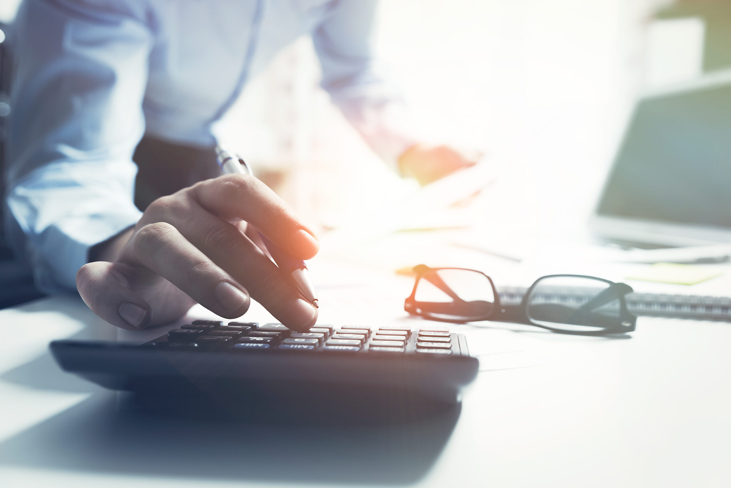 accountant at his desk typing on his keyboard