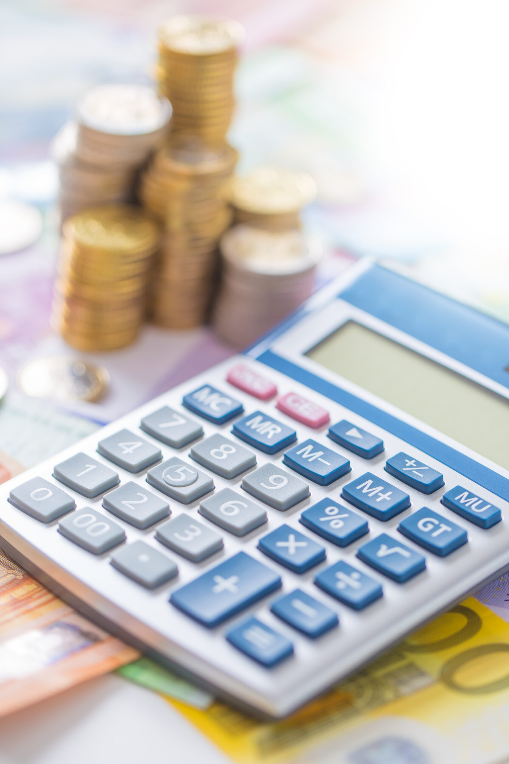 calculator with money/coins in background