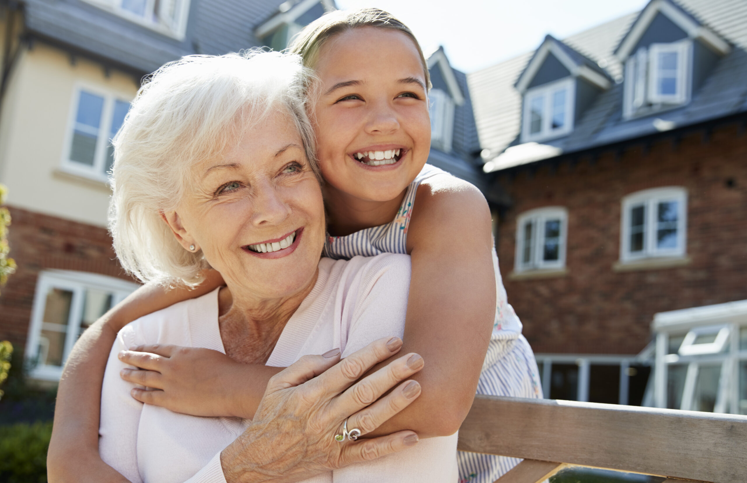 grandmother with grandchild outside of family home