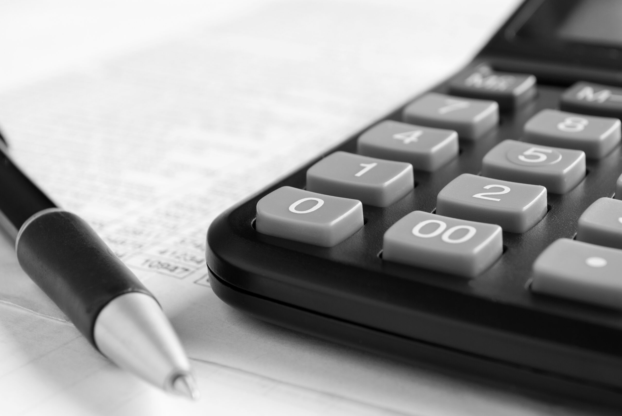 CPA accountant calculator and pen on top of tax documents